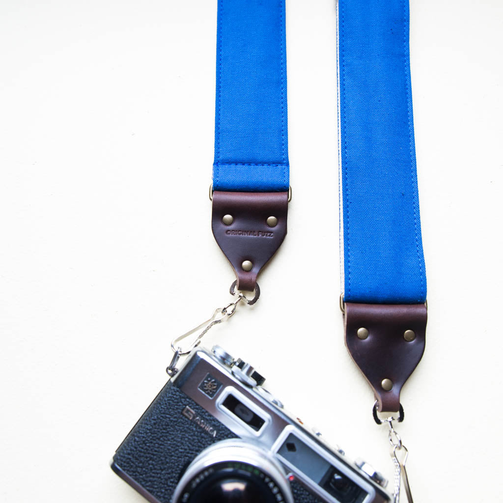 Blue vintage-style cotton canvas camera strap made by Original Fuzz in Nashville with a Yashica film camera.