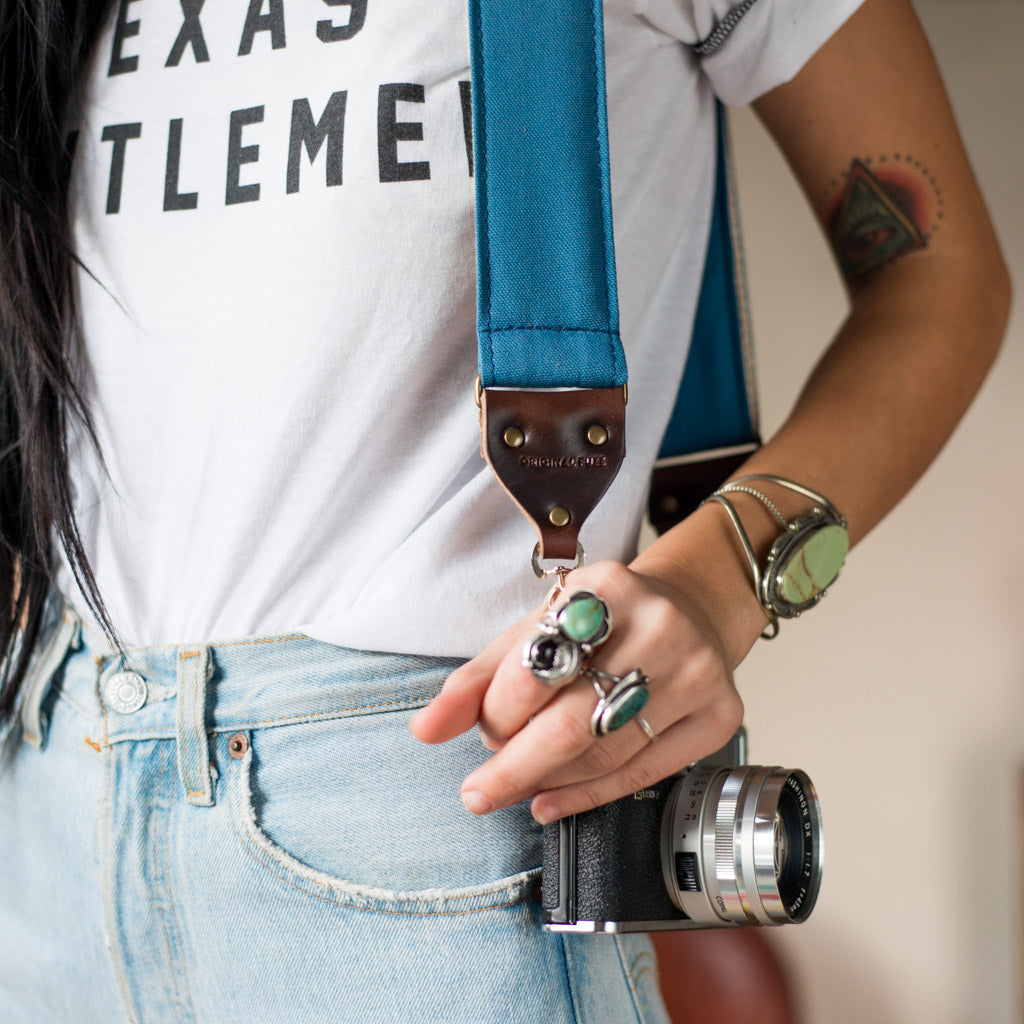Blue vintage-style cotton canvas camera strap made by Original Fuzz in Nashville with a Yashica film camera.