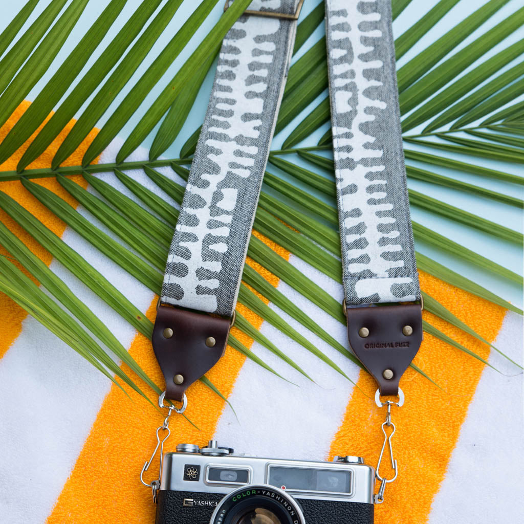 White and gray vintage-style camera strap made with fabric block printed in India by Original Fuzz in Nashville, TN.