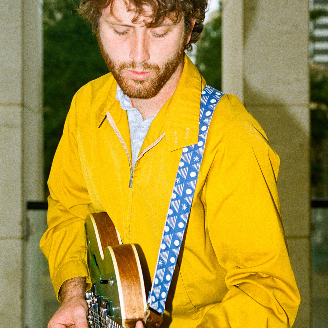 Real Estate's bassist Alex Bleeker designed this skinny guitar strap for Original Fuzz made with blue cotton and silkscreened by Grand Palace with white ink in Nashville, TN.