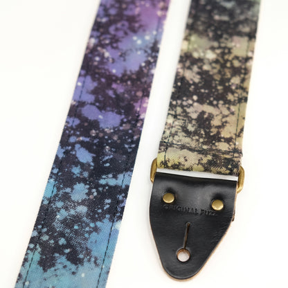 End-tab detail view of guitar strap in multi-colored over black base hand-dyed canvas fabric with black leather end-tab. Made in Nashville by Original Fuzz.