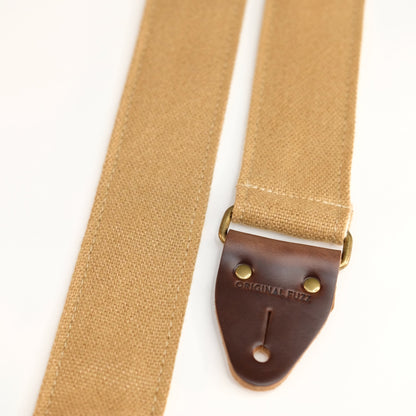 End-tab detail view of guitar strap in tan woven fabric with brown leather end-tab. Made in Nashville by Original Fuzz.