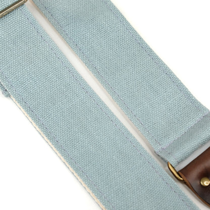 Fabric detail view of guitar strap in light blue woven fabric with brown leather end-tab. Made in Nashville by Original Fuzz.
