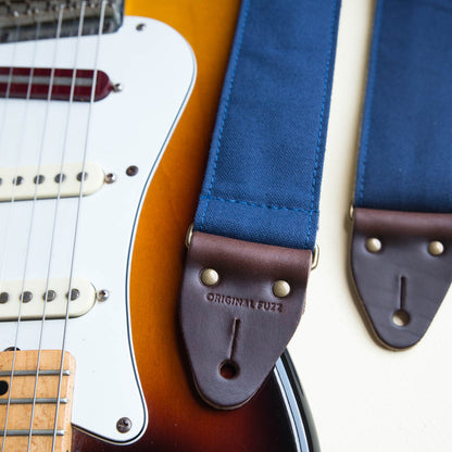 Navy blue cotton canvas guitar strap made by Original Fuzz with a Fender Jazzmaster.
