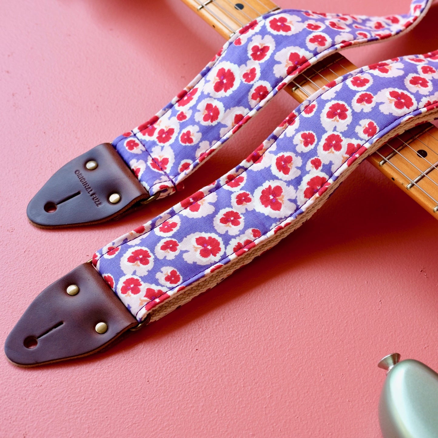 Purple and red classic floral pattern lightweight cotton handmade guitar strap with a Fender guitar. 