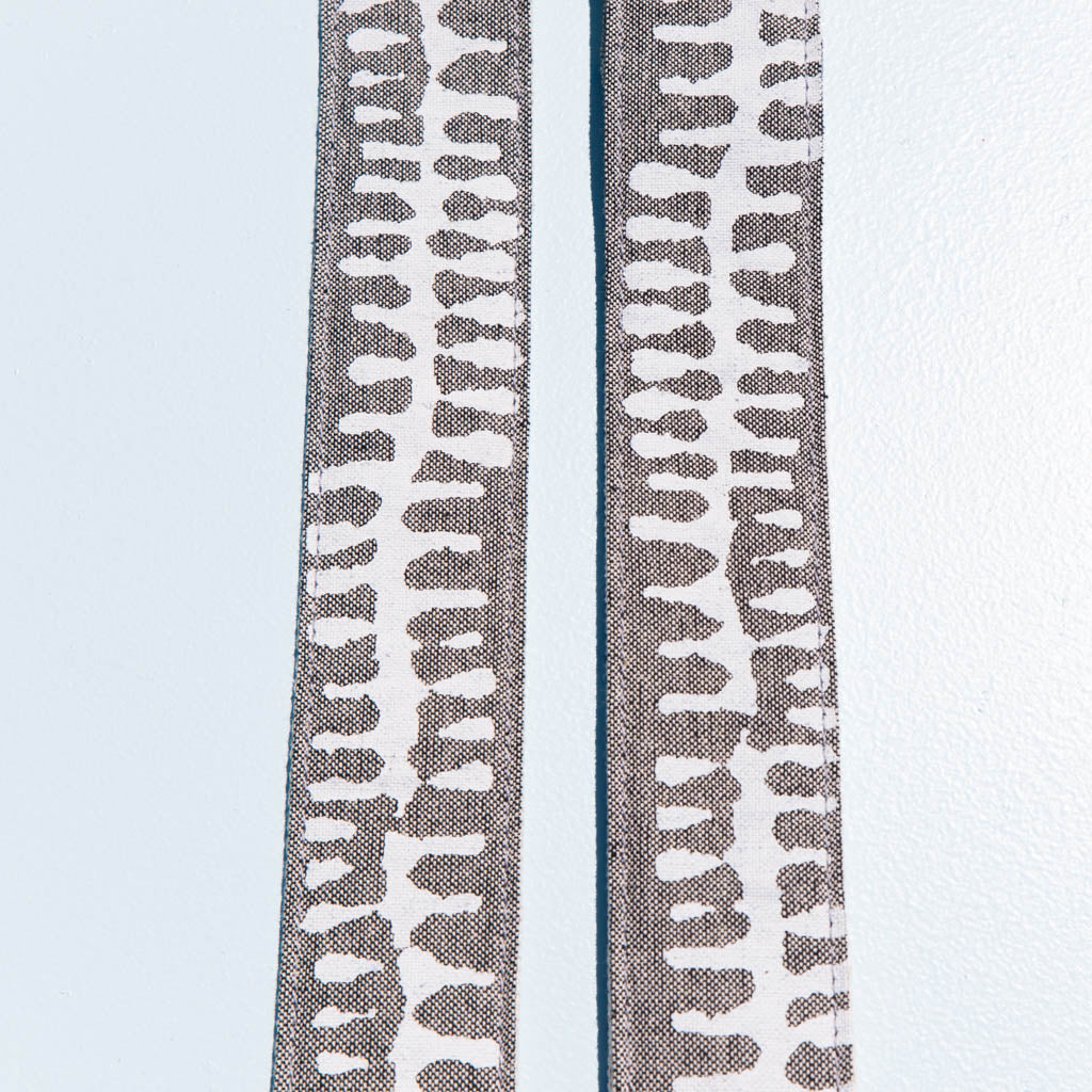White and gray vintage-style camera strap made with fabric block printed in India by Original Fuzz in Nashville, TN. 