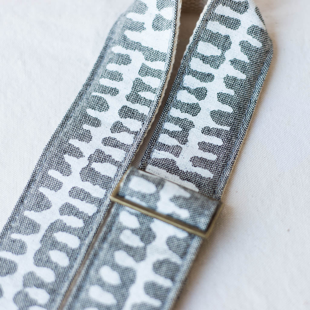 White and gray vintage-style camera strap made with fabric block printed in India by Original Fuzz in Nashville, TN. 