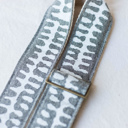 White and gray vintage-style camera strap made with fabric block printed in India by Original Fuzz in Nashville, TN. 