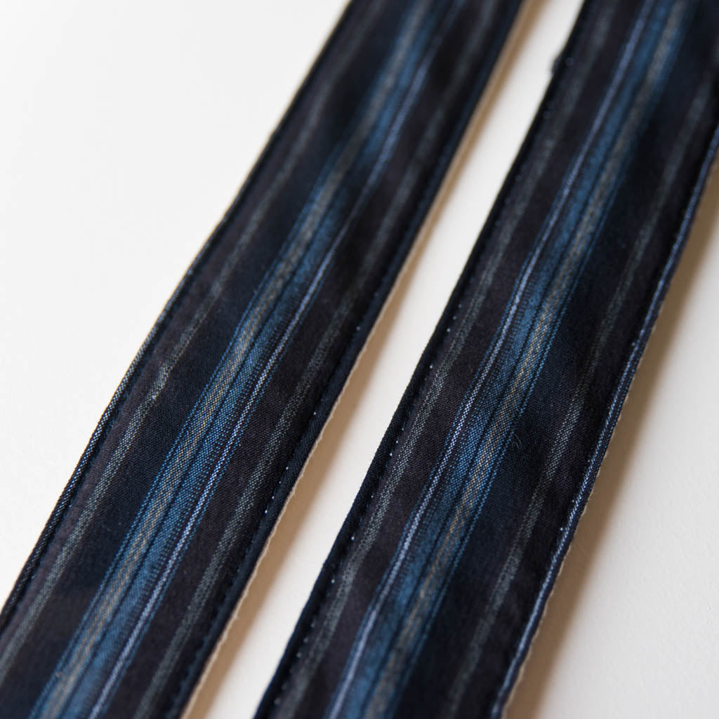Vintage-style guitar strap made with reclaimed black striped cotton by Original Fuzz.