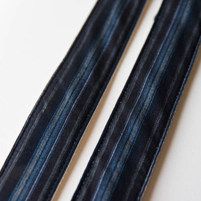 Vintage-style guitar strap made with reclaimed black striped cotton by Original Fuzz.