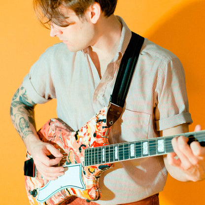 Vintage-style guitar strap made with reclaimed black striped cotton by Original Fuzz.