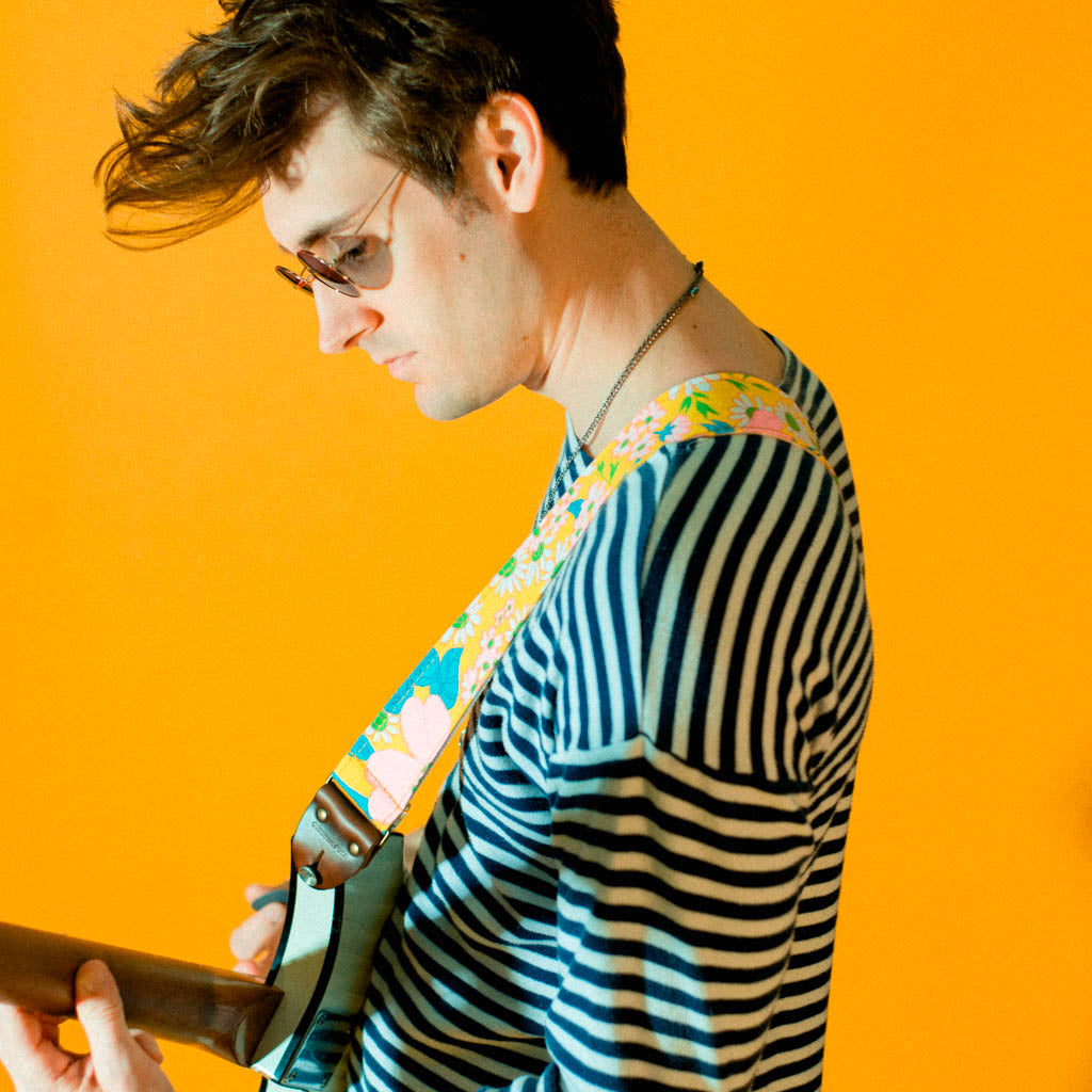 Original Fuzz vintage-style guitar strap made with repurposed yellow floral fabric.