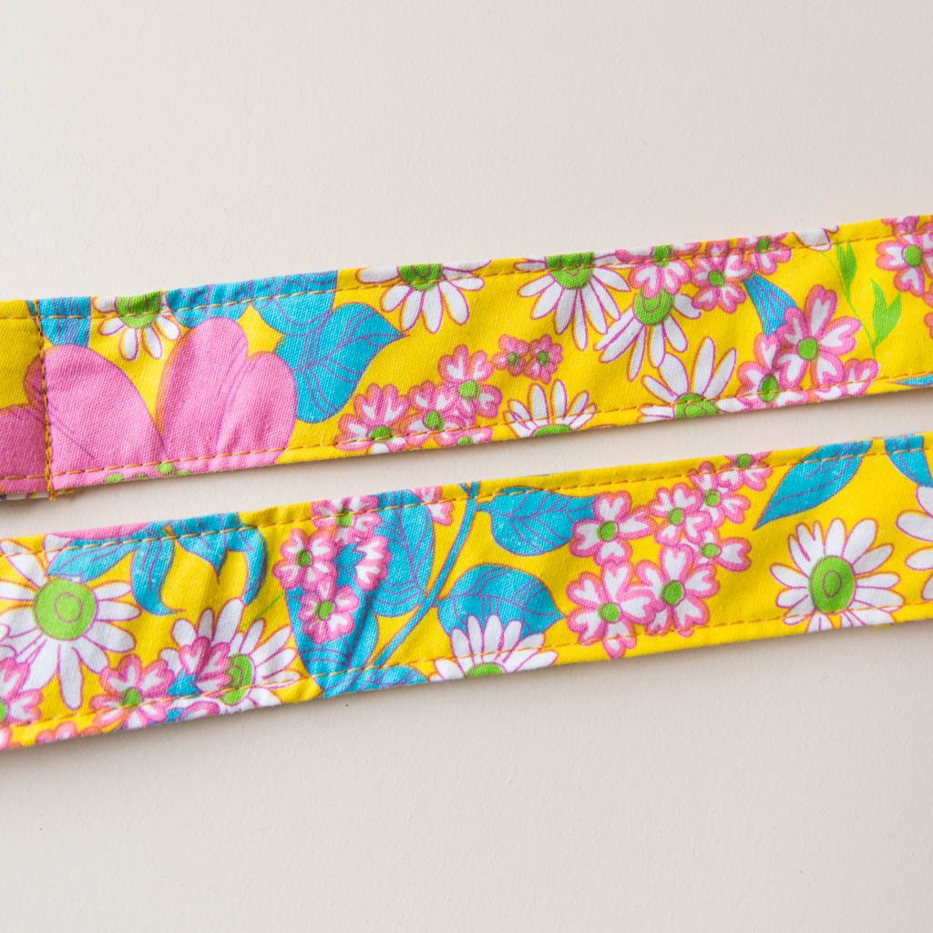 Original Fuzz vintage-style guitar strap made with repurposed yellow floral fabric.