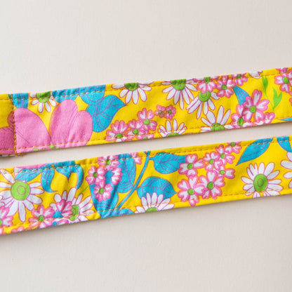 Original Fuzz vintage-style guitar strap made with repurposed yellow floral fabric.