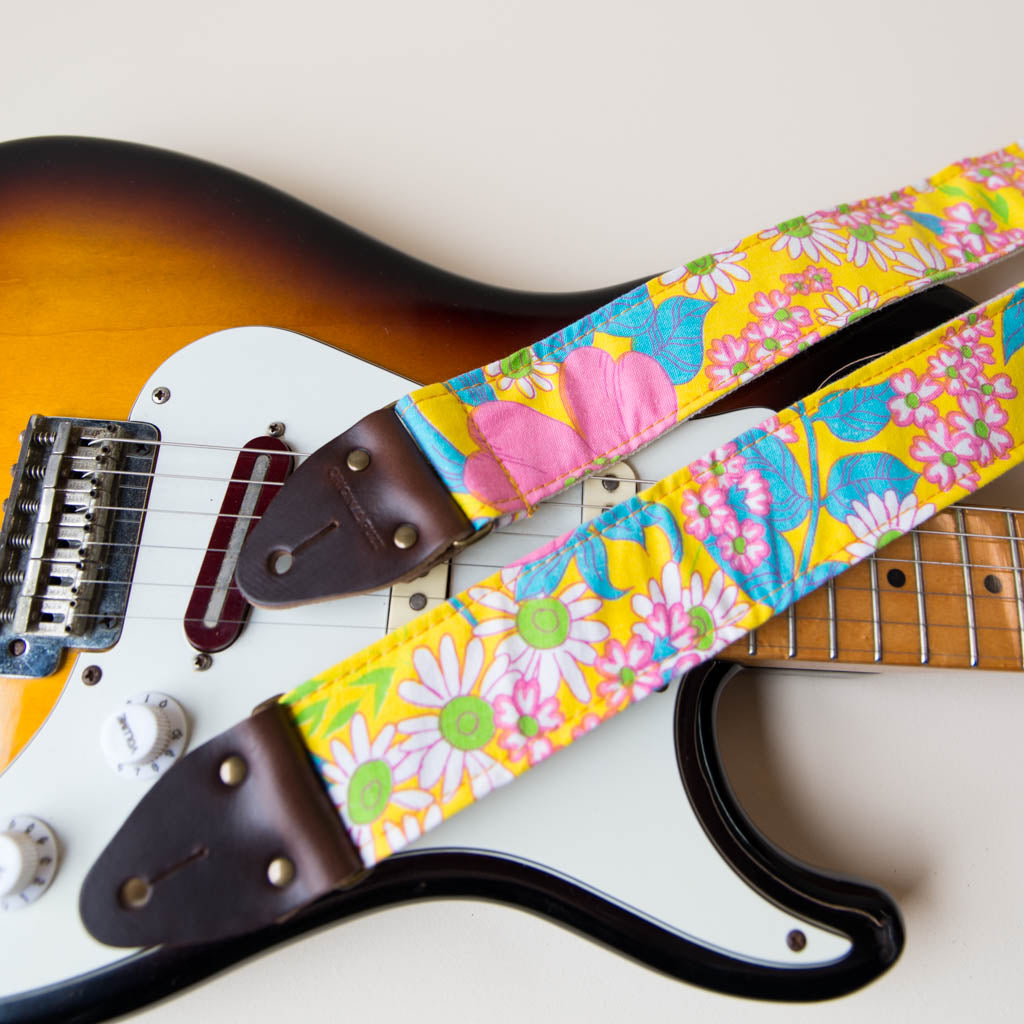 Original Fuzz vintage-style guitar strap made with repurposed yellow floral fabric.