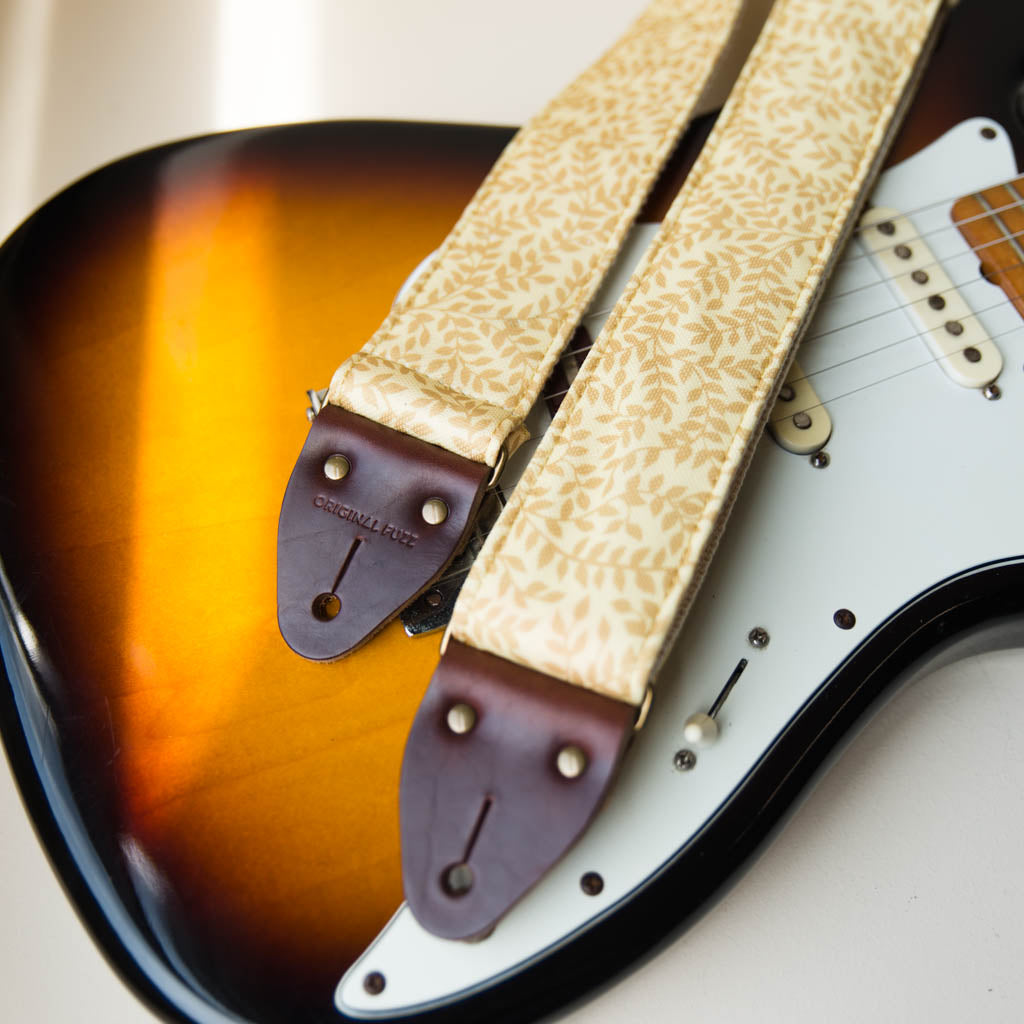 Vintage guitar strap made with repurposed yellow polyester with a repeating leaf design by Original Fuzz. 