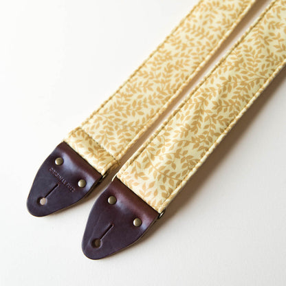 Vintage guitar strap made with repurposed yellow polyester with a repeating leaf design by Original Fuzz. 