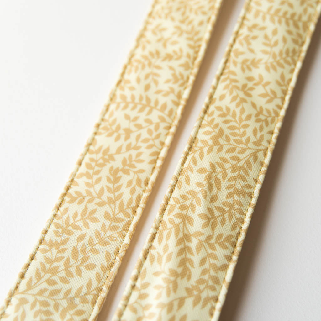 Vintage guitar strap made with repurposed yellow polyester with a repeating leaf design by Original Fuzz. 