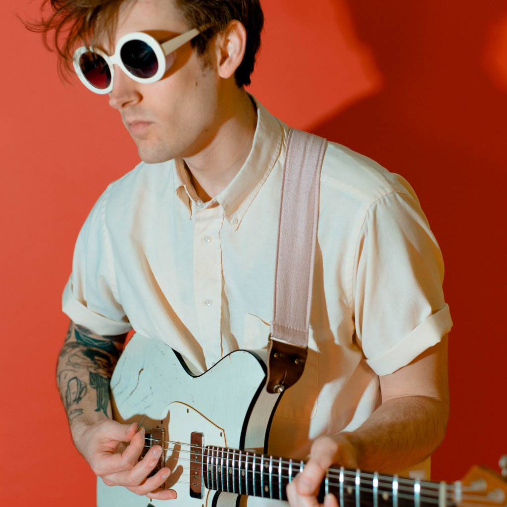 Light pink silk vintage guitar strap made by Original Fuzz. 