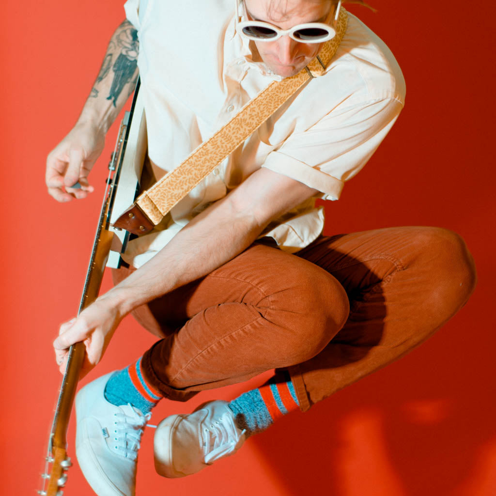 Vintage guitar strap made with repurposed yellow polyester with a repeating leaf design by Original Fuzz. 