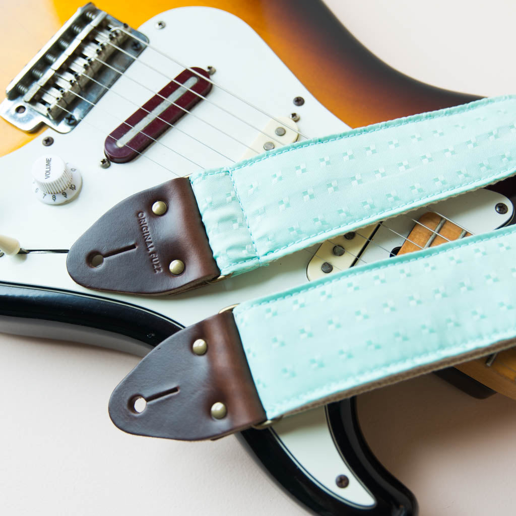 Vintage guitar strap made with light blue satin by Original Fuzz. 