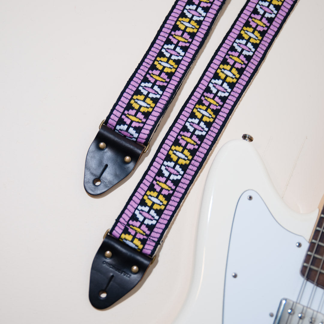 The vintage guitar strap in Everett street with a white Fender Jaguar